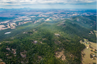 An aerial view of a lush, green landscape with a winding river or waterway cutting through the terrain.